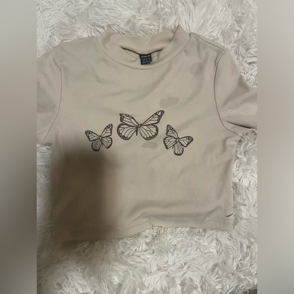 light brown shirt with darker brown butterflies. size :XS